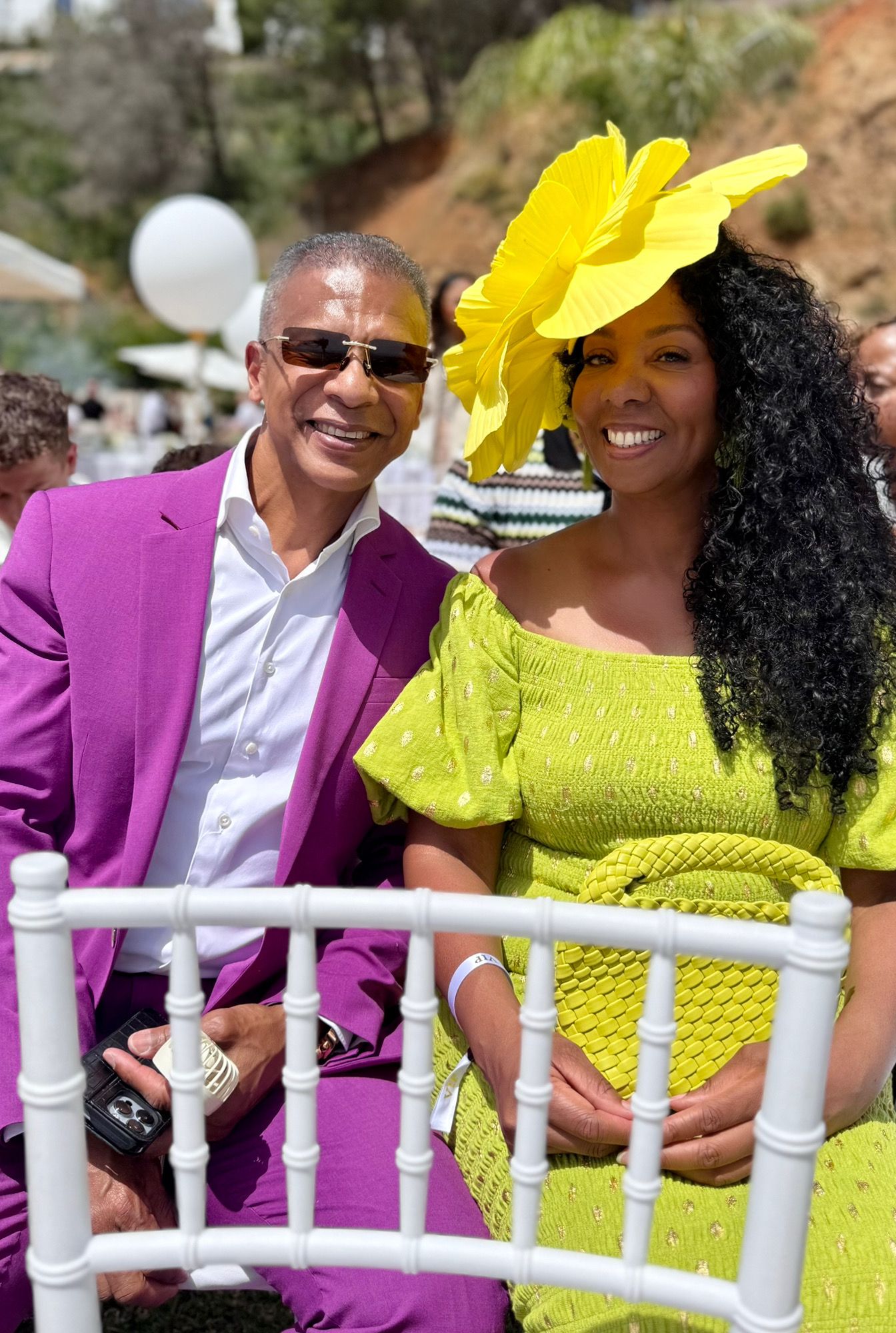 Health Tribe couple dressed in purple and yellow at a celebration
